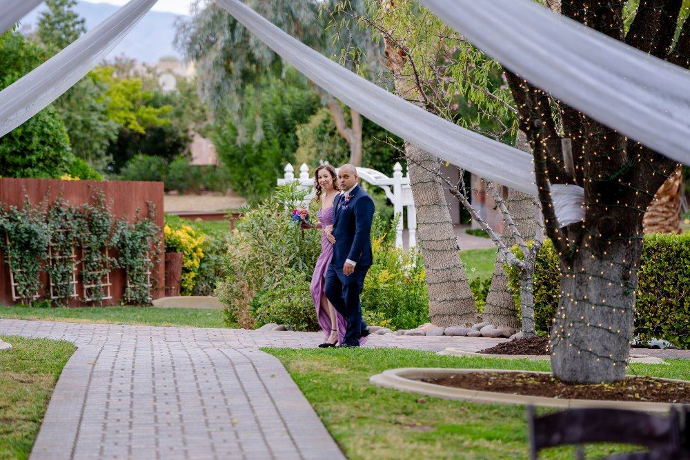 Las Vegas wedding photography — the bride walking under a draped white canopy