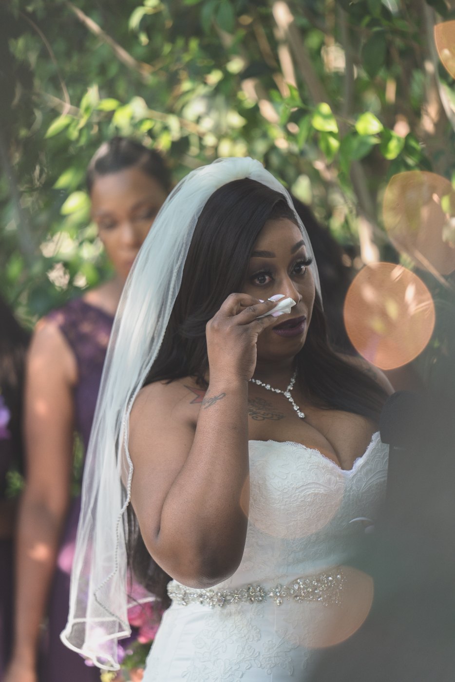 Las Vegas wedding photography — the bride wiping a tear during the ceremony