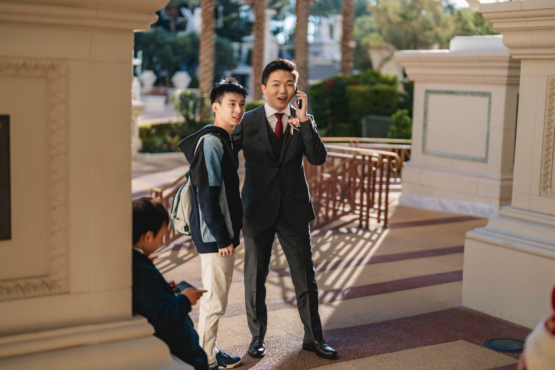 Las Vegas wedding photography — the groom taking a photo of family arriving