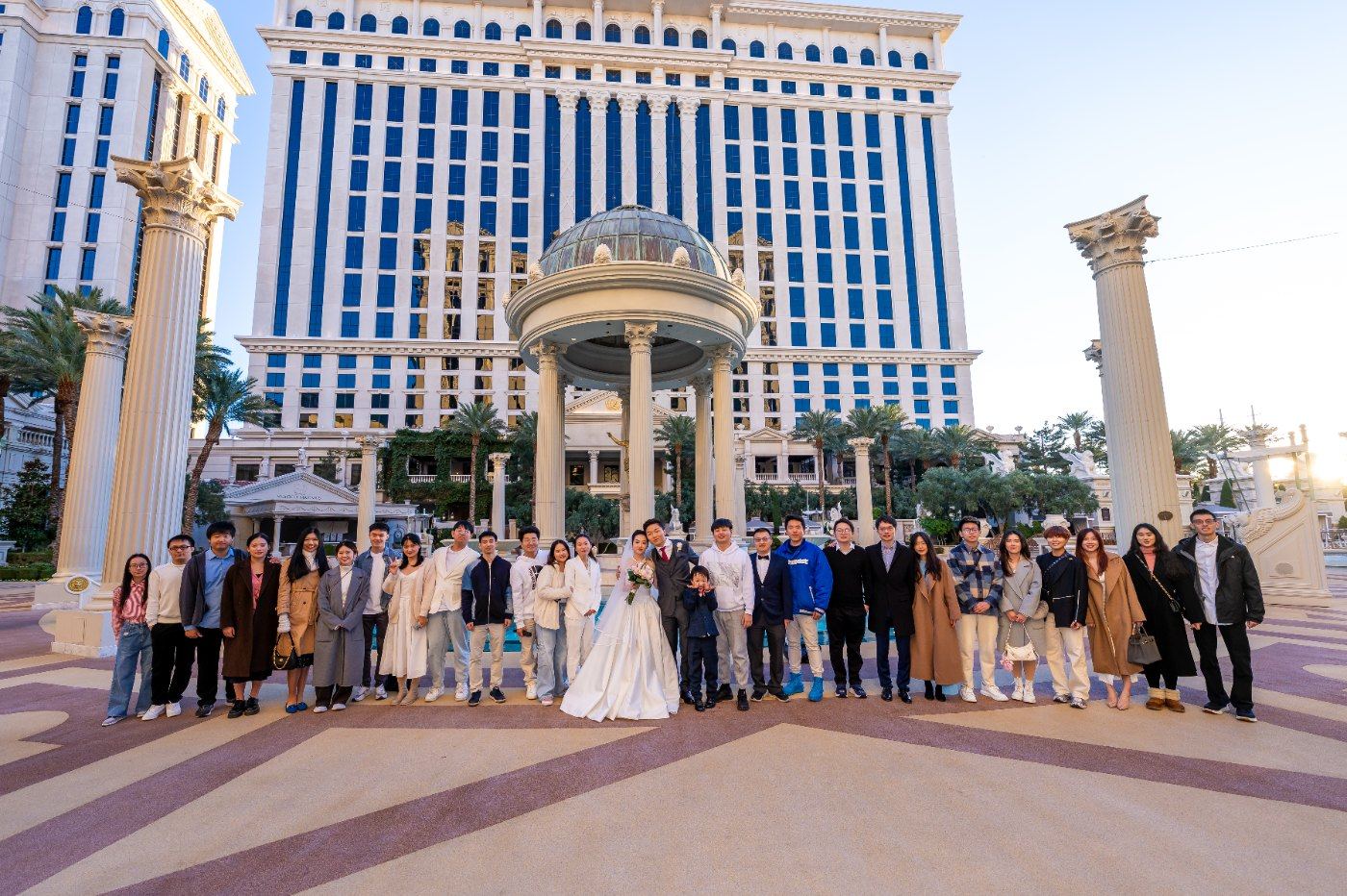 Las Vegas wedding photography — the whole group celebrating in front of Caesars Palace